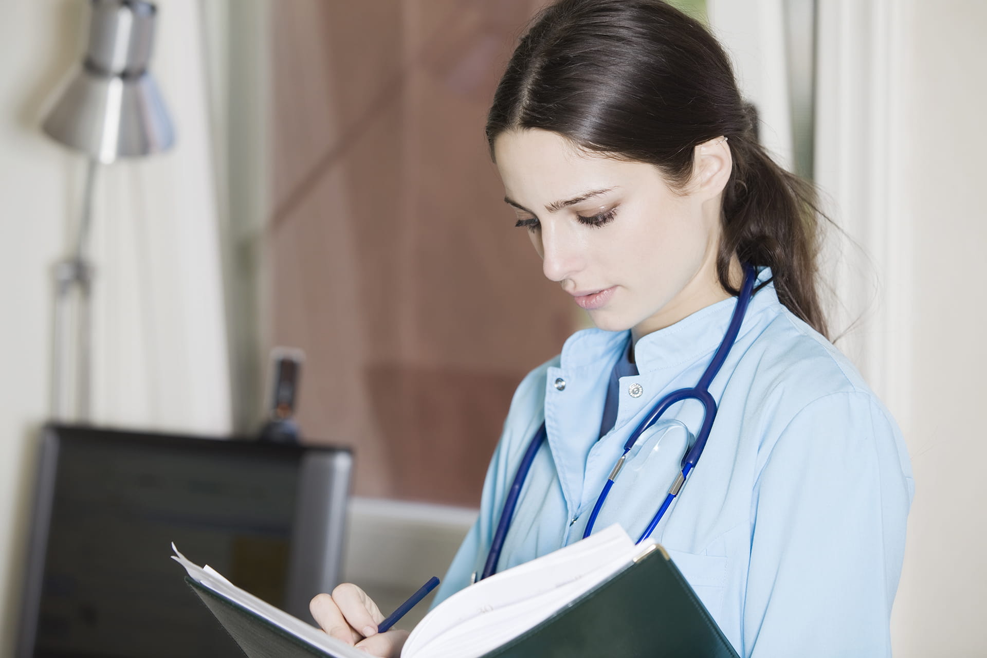 A female nurse writing